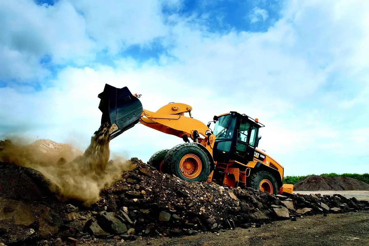 Wheel loader scooping dirt from a pile